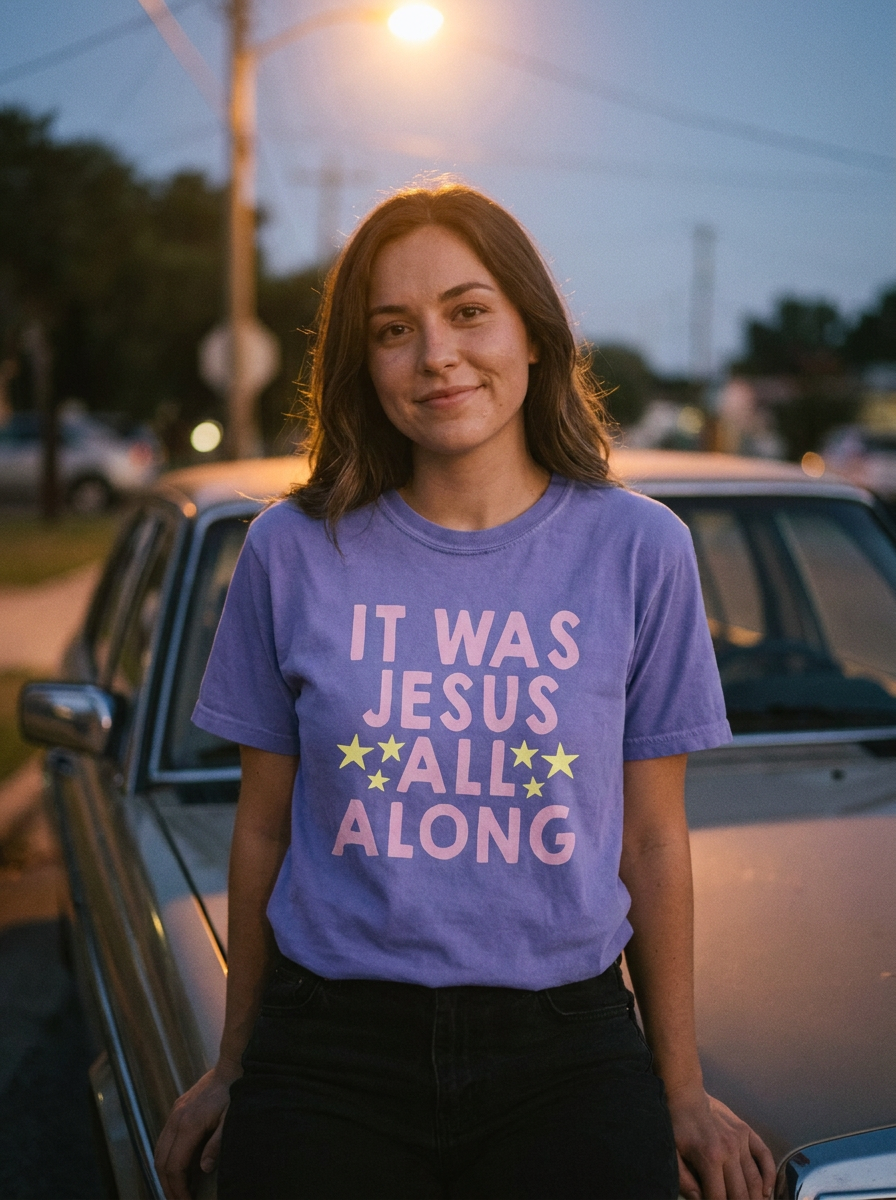 It Was Jesus All Along Christian tee, pink lettering and yellow stars on violet