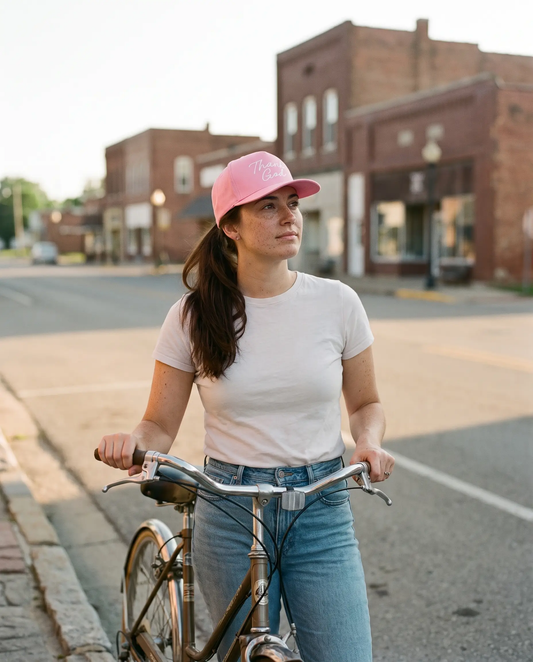 Model wearing the Thank God Script Hat, White on Pink, second view