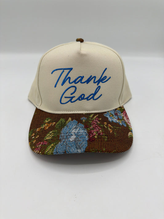 Thank God in royal blue script on a cream crown with a brown floral tapestry brim
