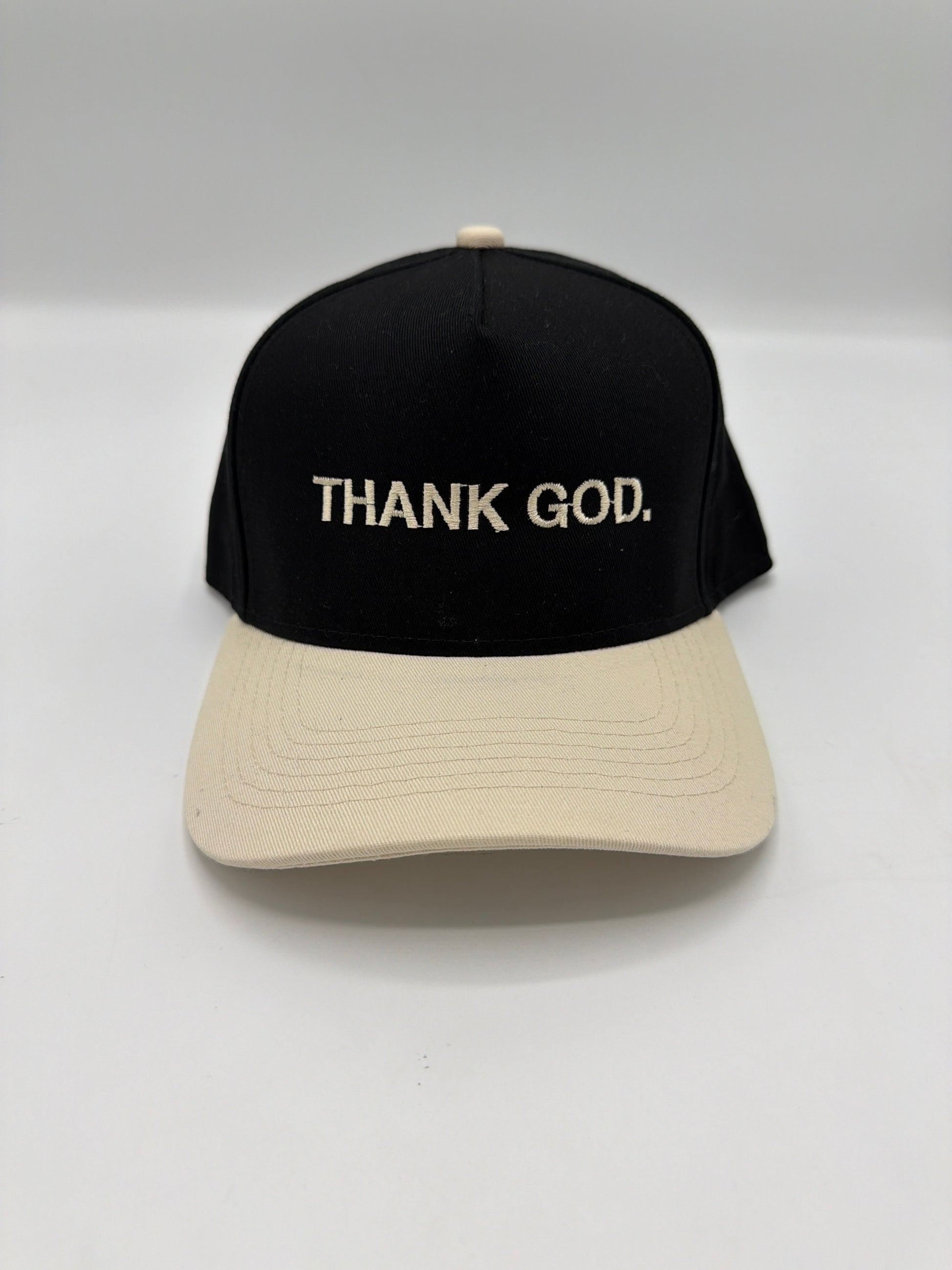 Thank God in cream puff embroidery on a black crown with a cream brim