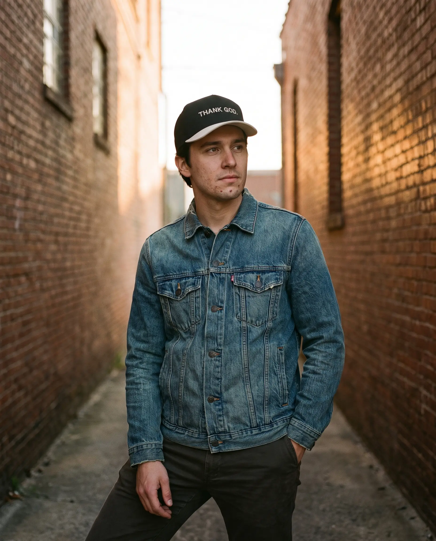 Model wearing the Thank God Hat, Black and Cream, second view