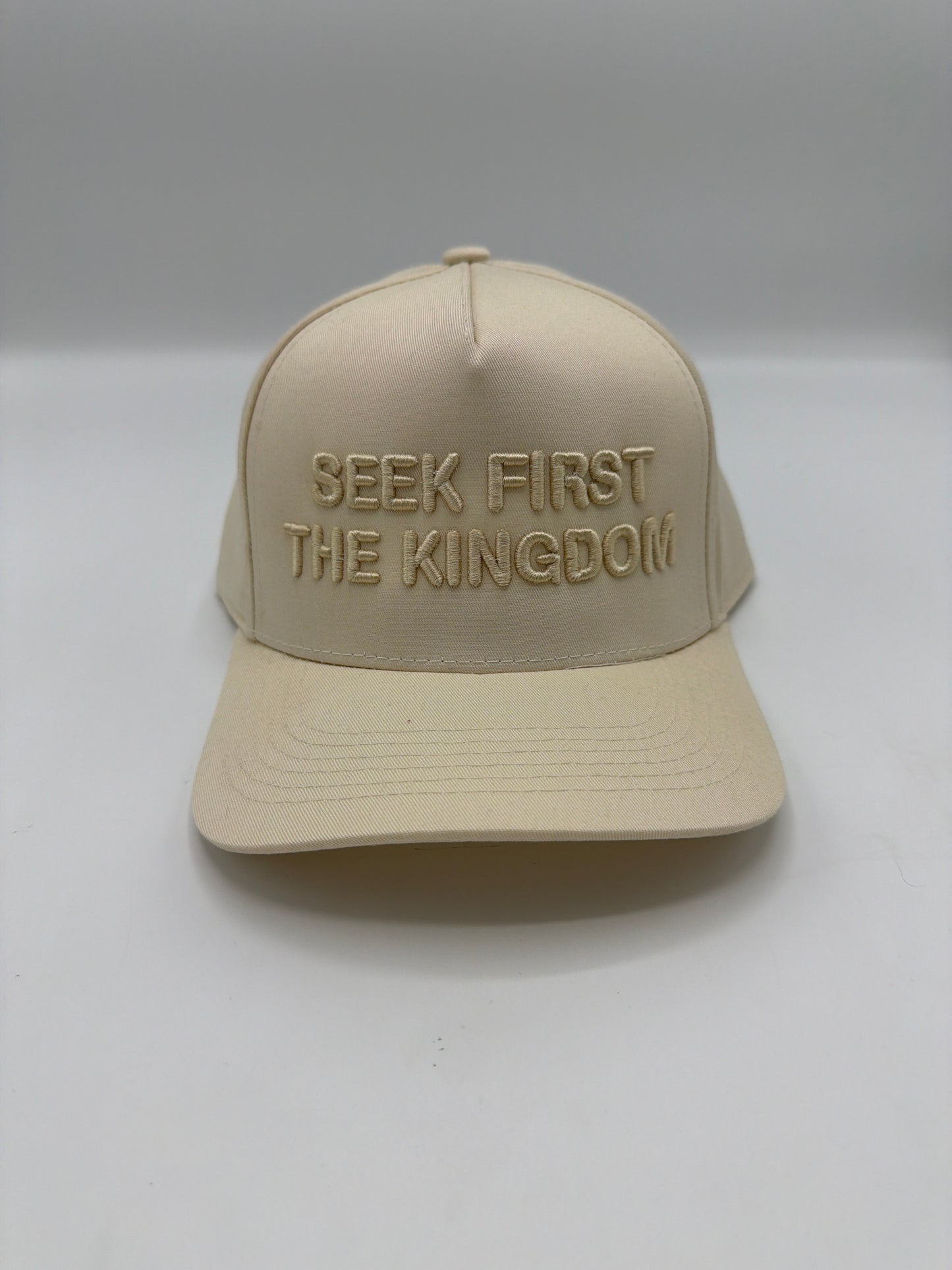 Seek First The Kingdom in tonal cream puff embroidery on a cream five panel snapback