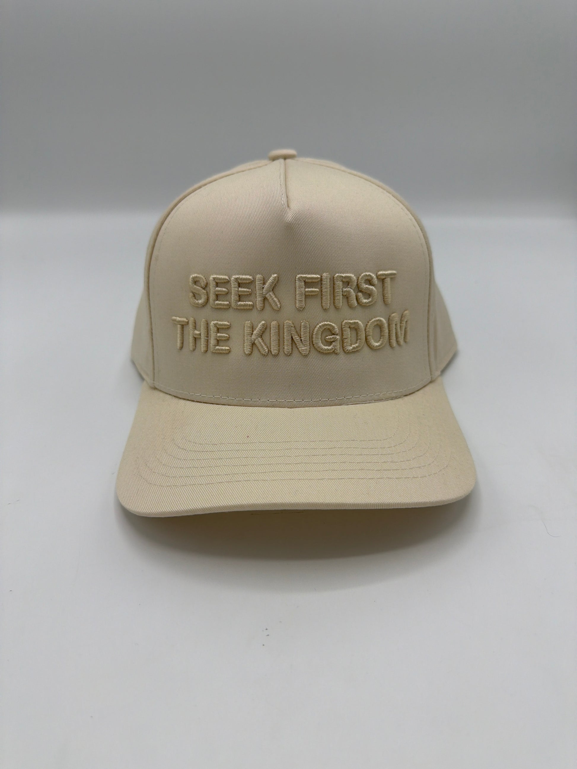 Seek First The Kingdom in tonal cream puff embroidery on a cream five panel snapback
