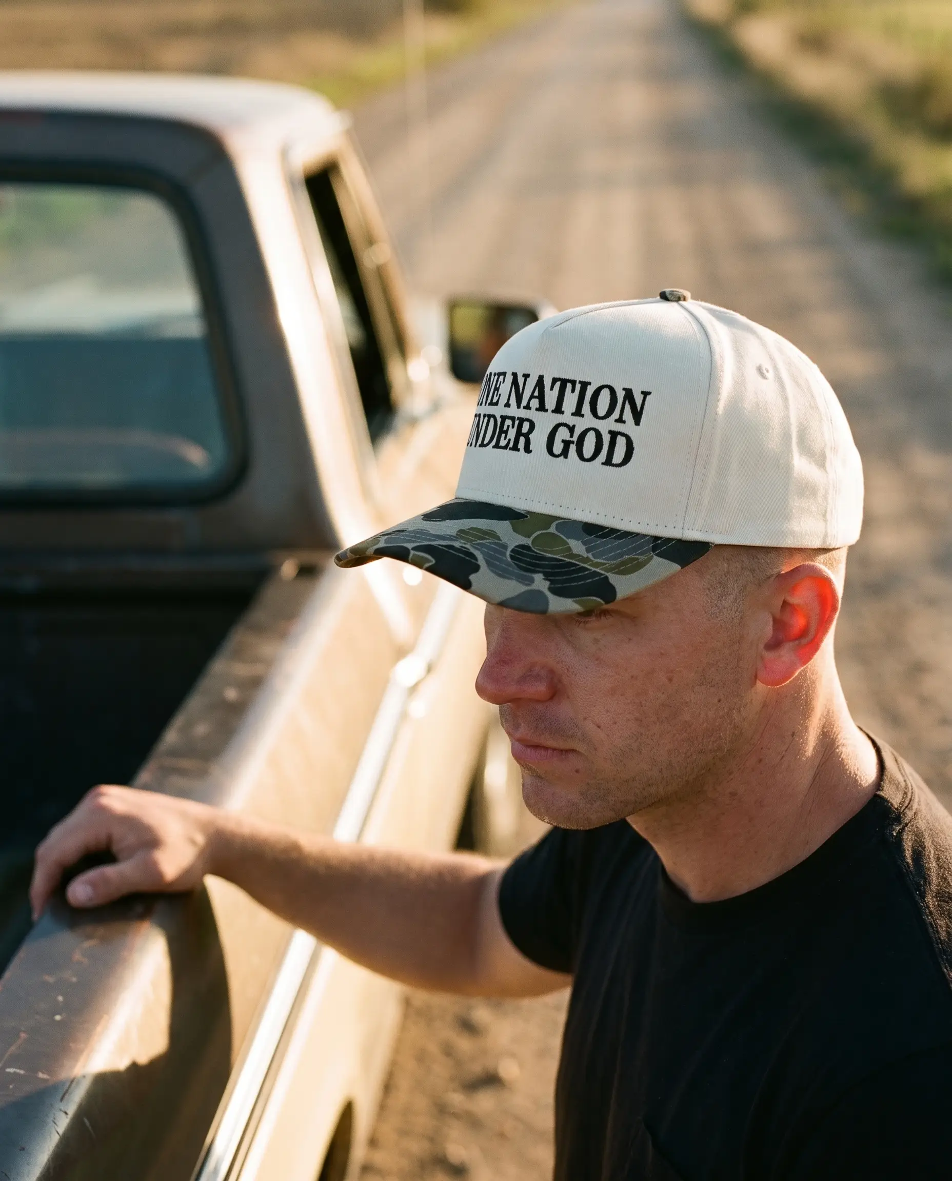 Model wearing the One Nation Under God Hat, Serif, second view