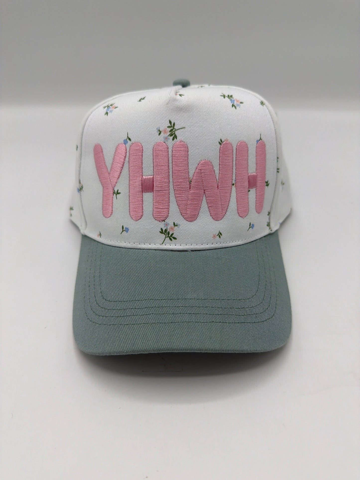 YHWH in dusty pink puff embroidery on a floral crown with a sage green brim