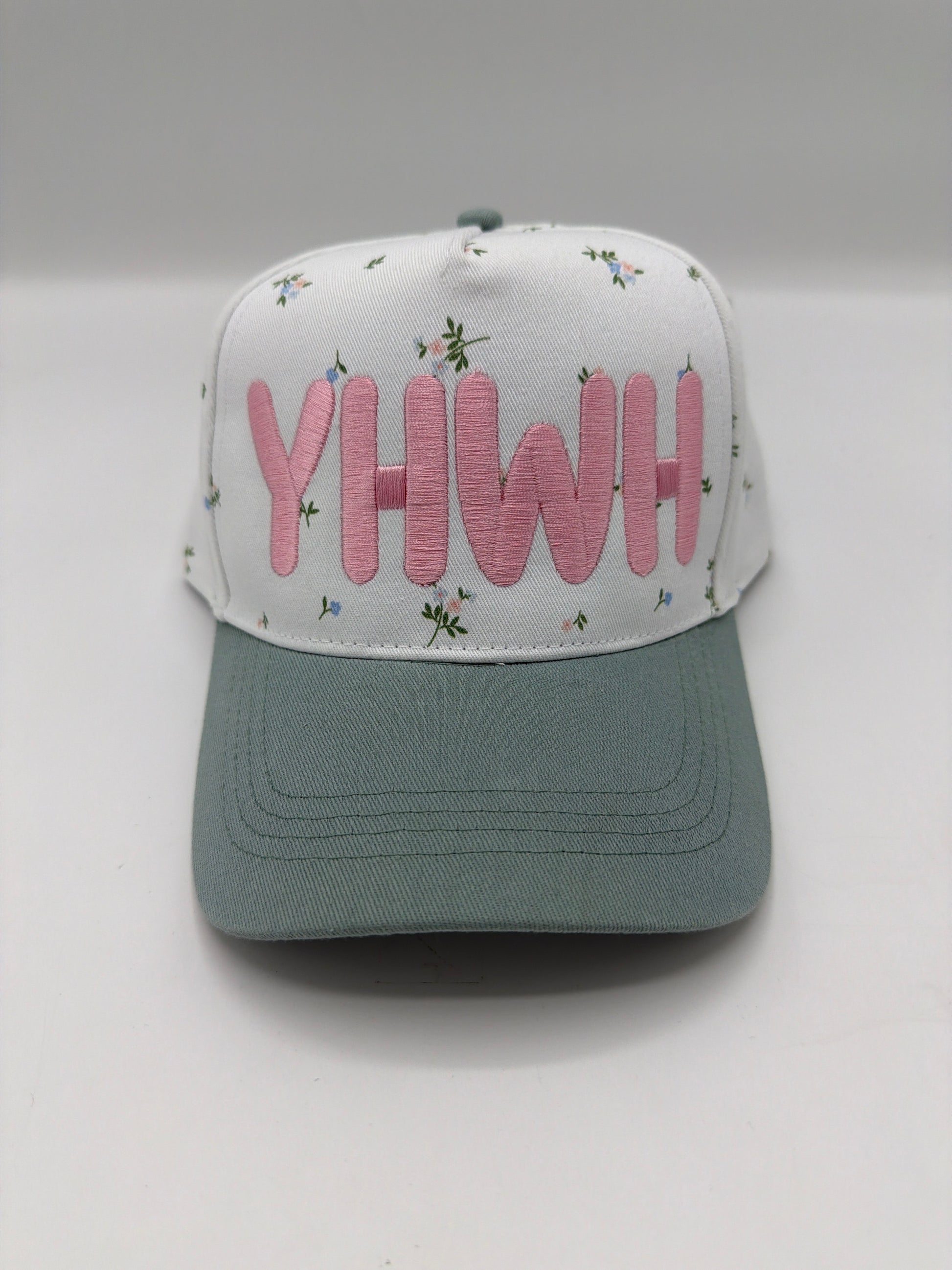 YHWH in dusty pink puff embroidery on a floral crown with a sage green brim