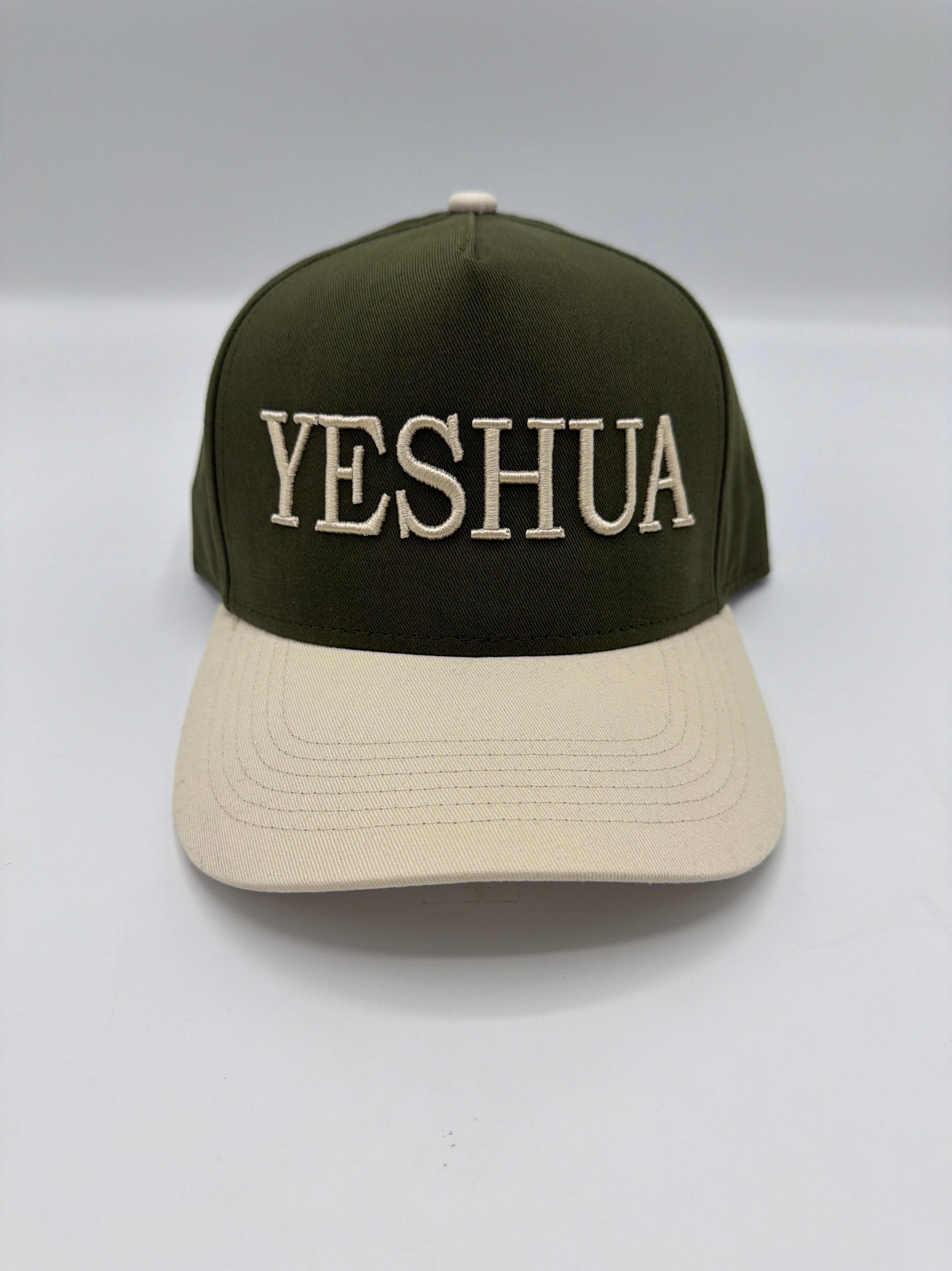Yeshua embroidered in cream on an olive five panel snapback with a cream brim