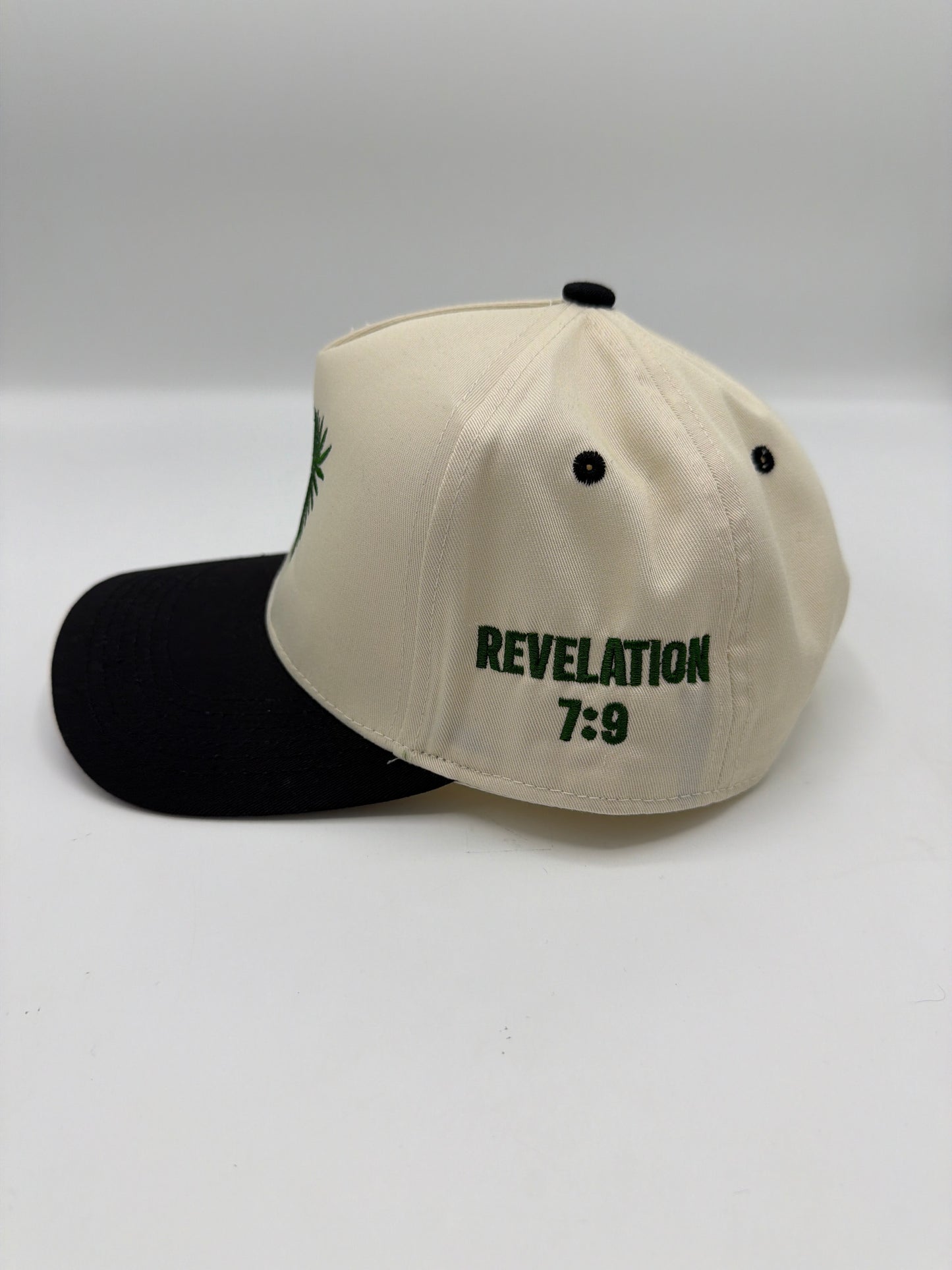 Revelation 7:9 embroidered on the side panel of the cream and black palm leaf hat