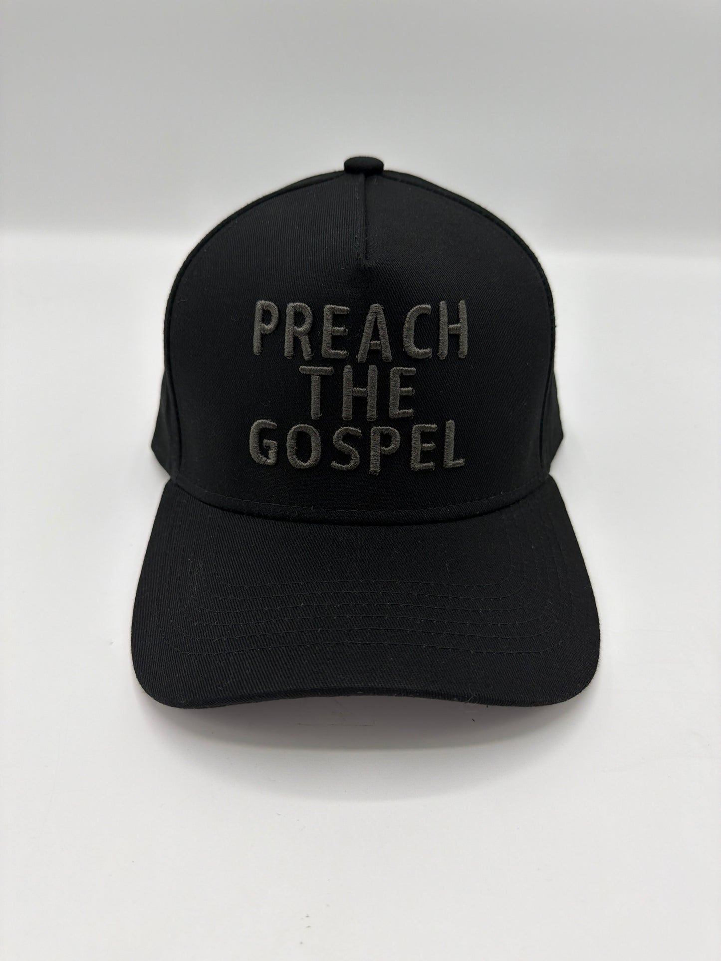 Preach The Gospel in tonal charcoal puff embroidery on an all black five panel snapback