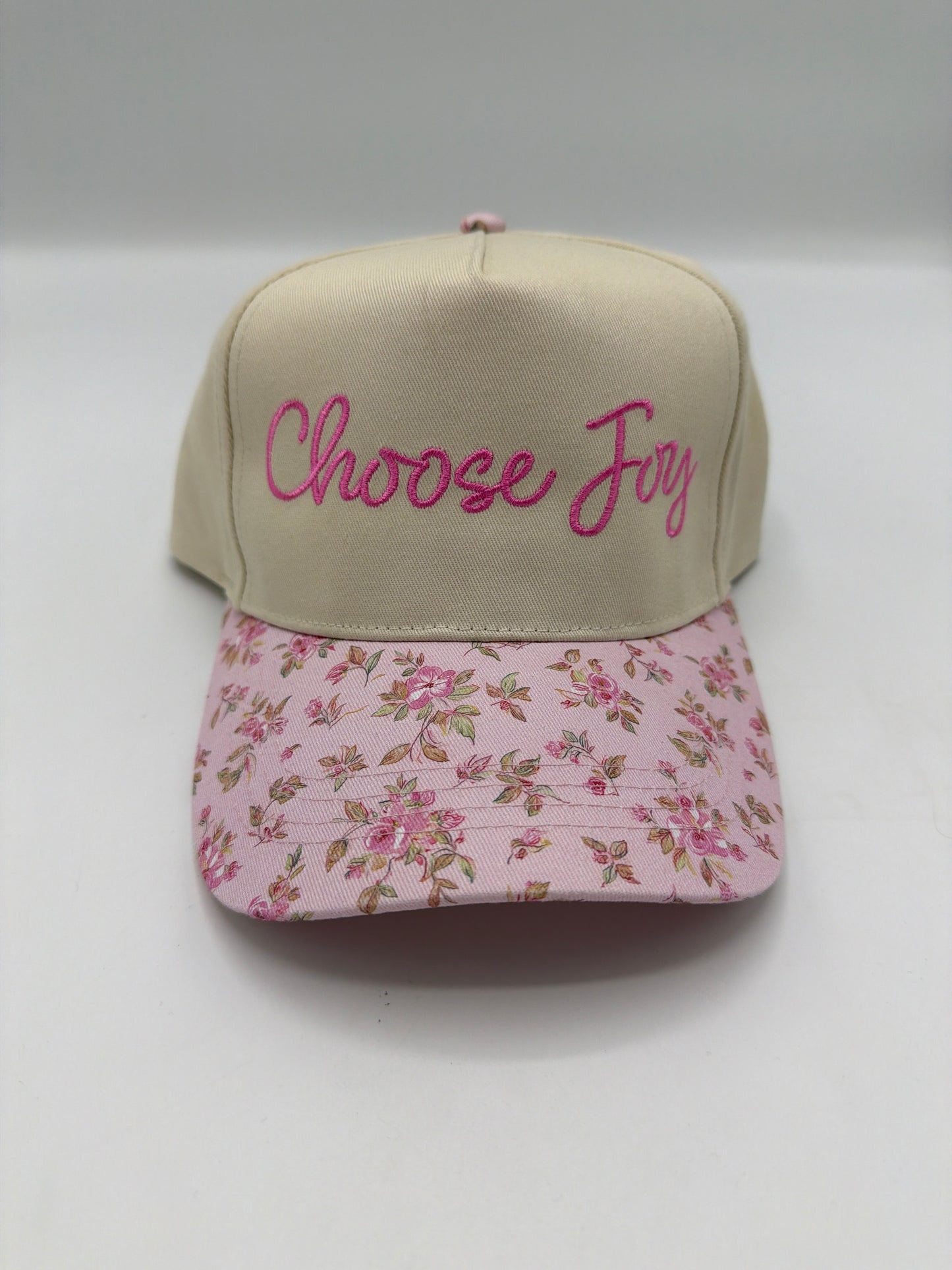 Choose Joy in hot pink script on a khaki crown with a pink rose floral brim