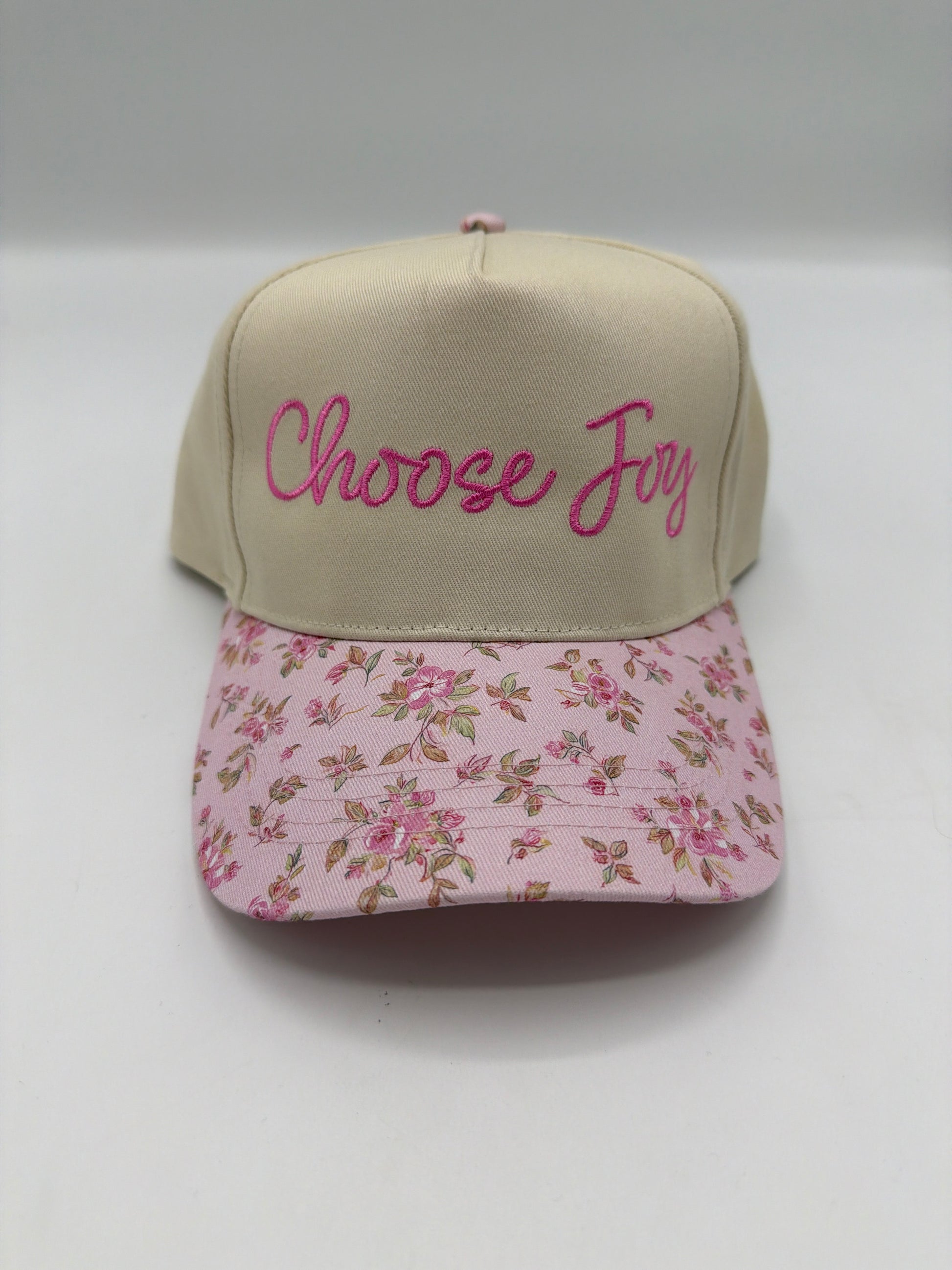 Choose Joy in hot pink script on a khaki crown with a pink rose floral brim