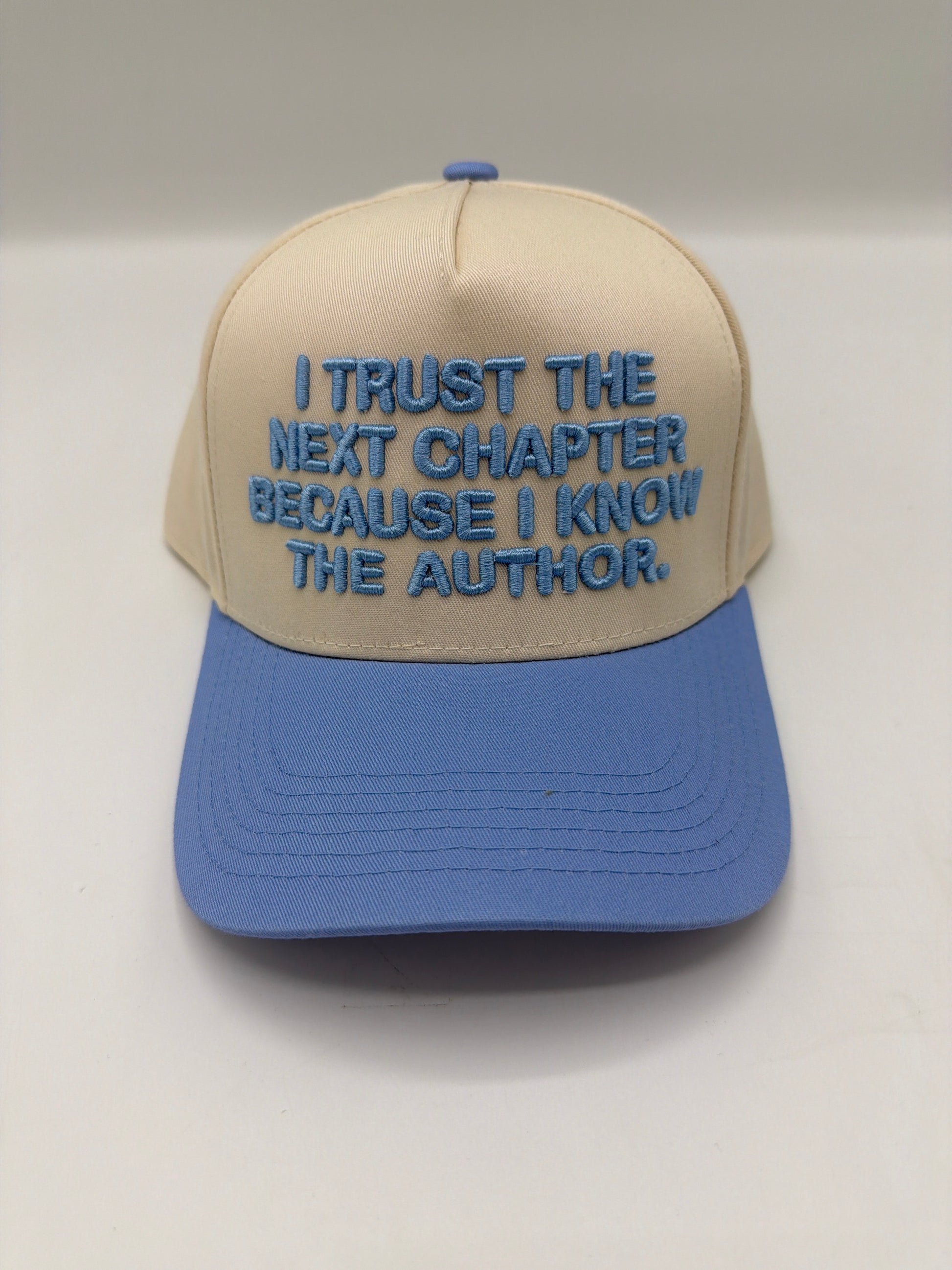 I trust the next chapter because I know the Author, embroidered on a cream crown with a periwinkle brim