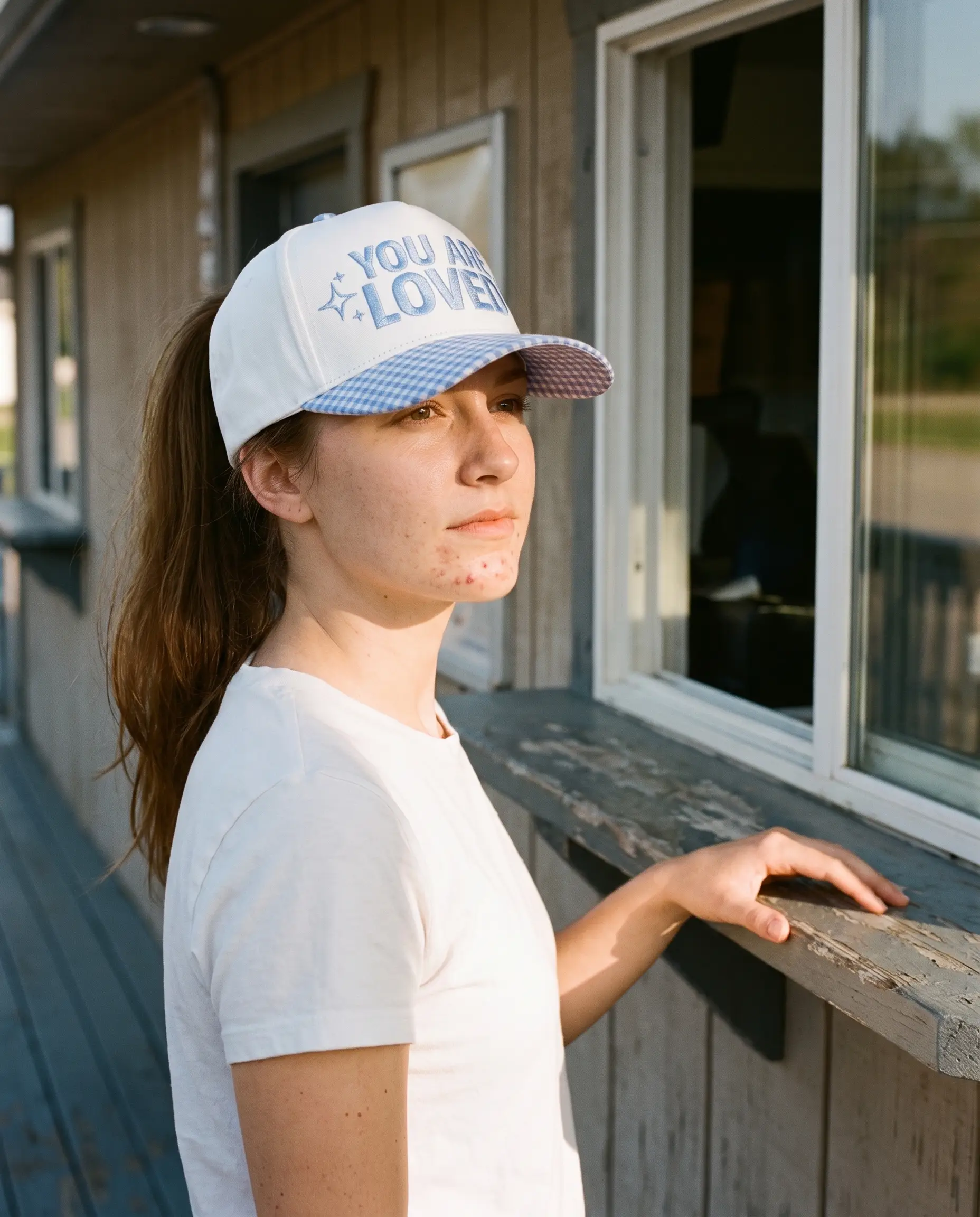 Model wearing the You Are Loved Hat, Blue Gingham, second view