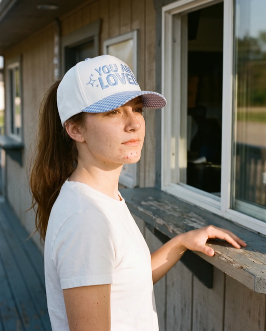 Model wearing the You Are Loved Hat, Blue Gingham, second view
