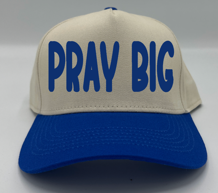 Pray Big in royal blue embroidery on a natural crown with a royal blue brim