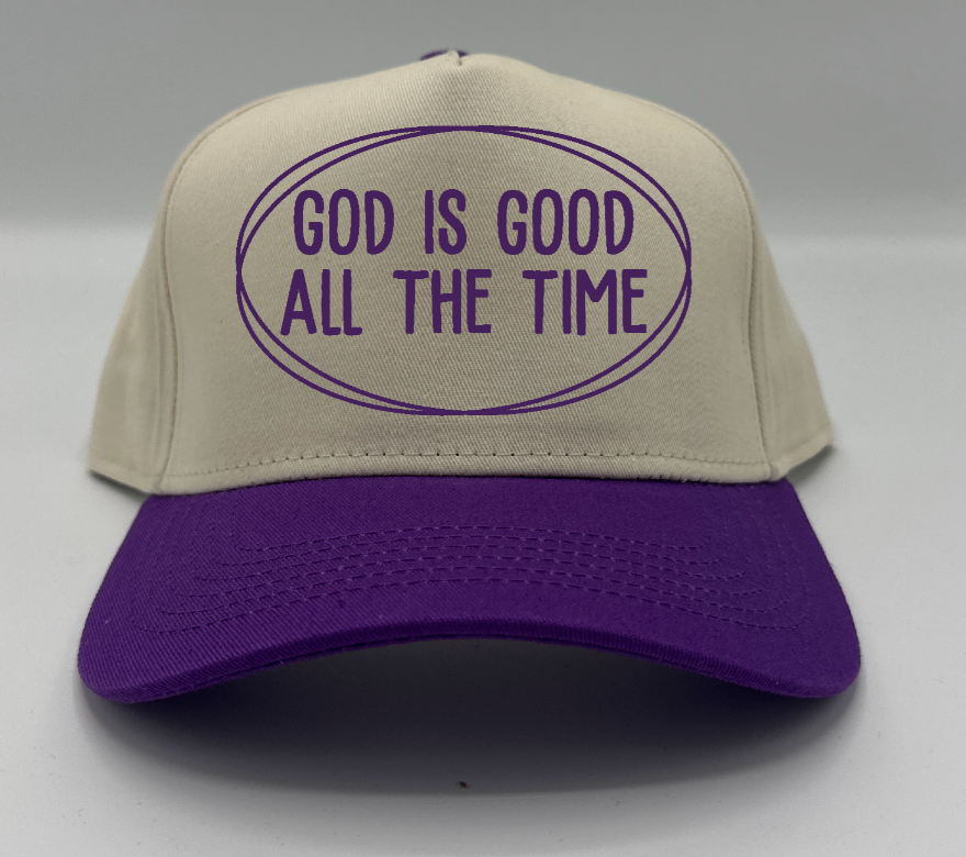 God Is Good All The Time in purple embroidery on a natural crown with a purple brim