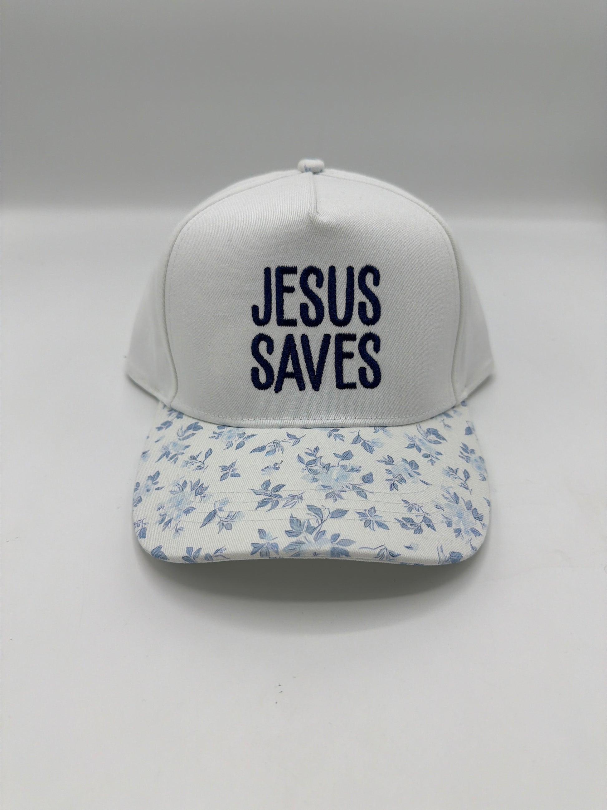 Jesus Saves in navy block embroidery on a white crown with a blue floral brim