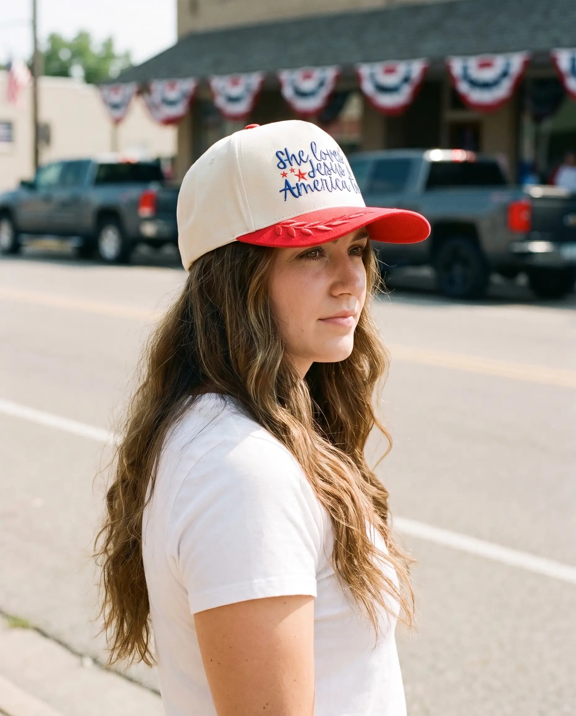 Model wearing the She Loves Jesus and America Too Hat, Red