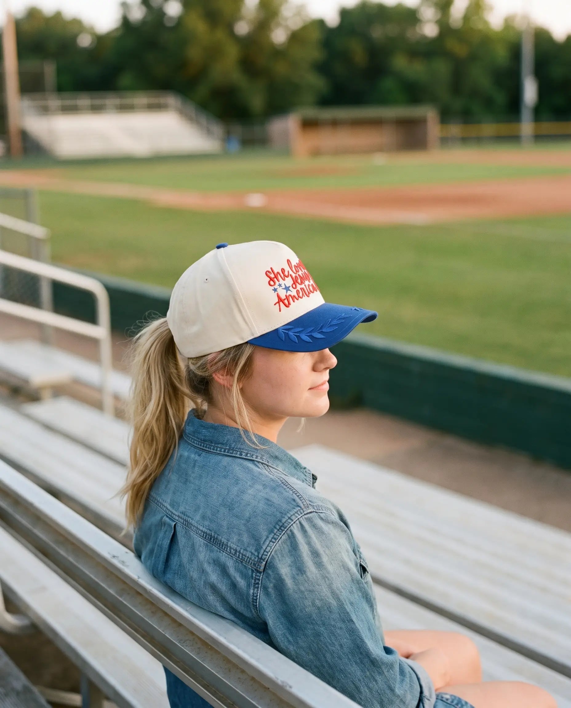 Model wearing the She Loves Jesus and America Too Hat, Royal Blue
