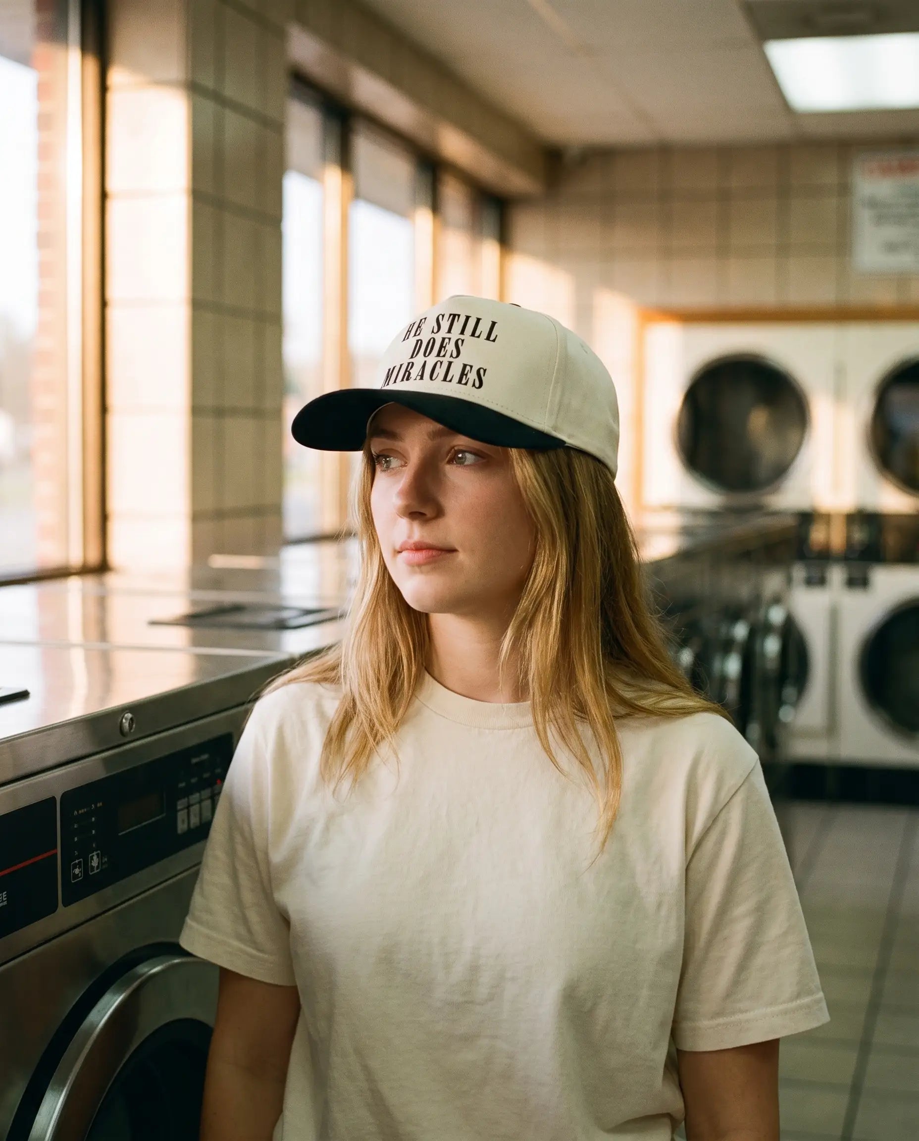Model wearing the He Still Does Miracles Hat, Black