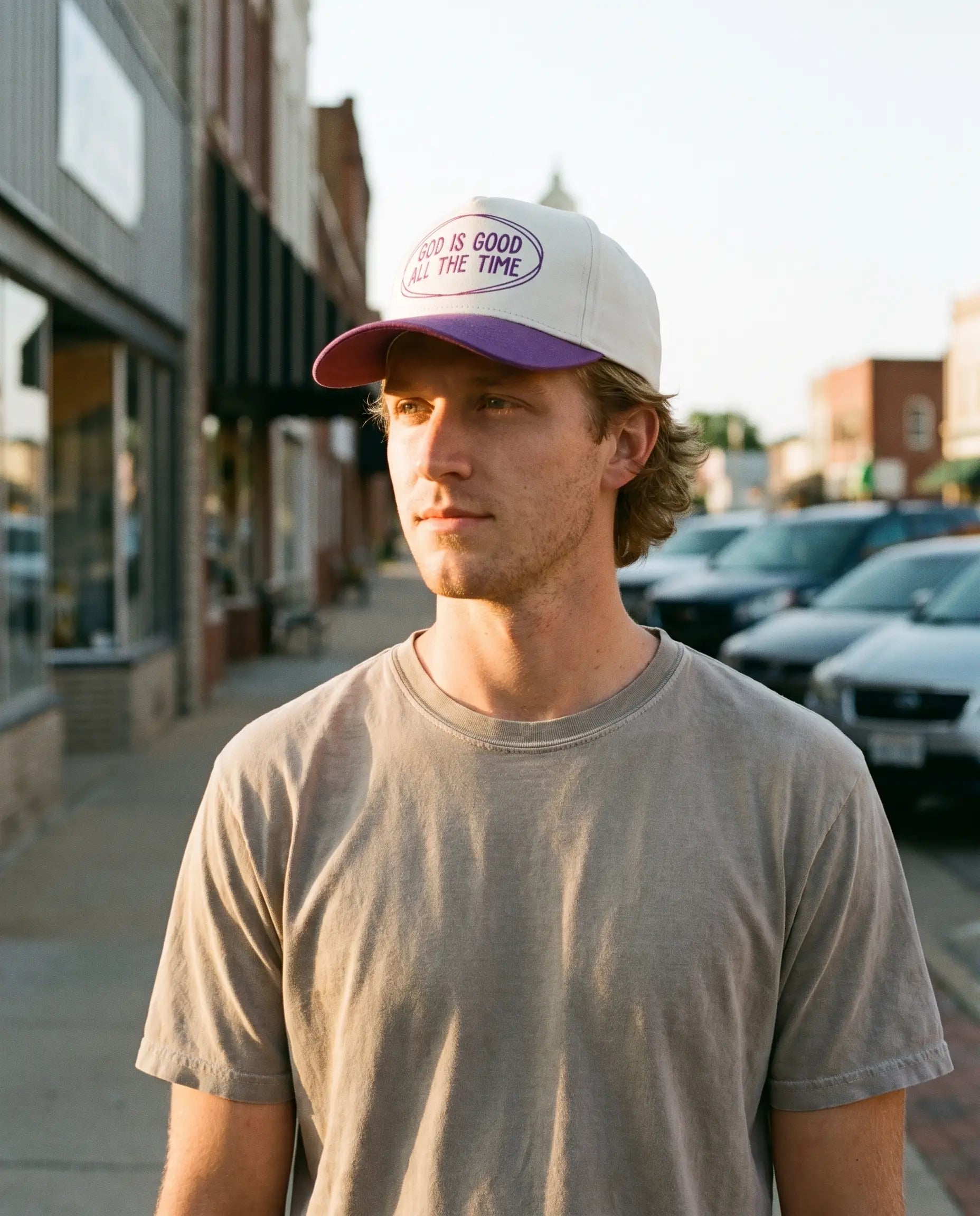 Model wearing the God Is Good All The Time Hat, Purple