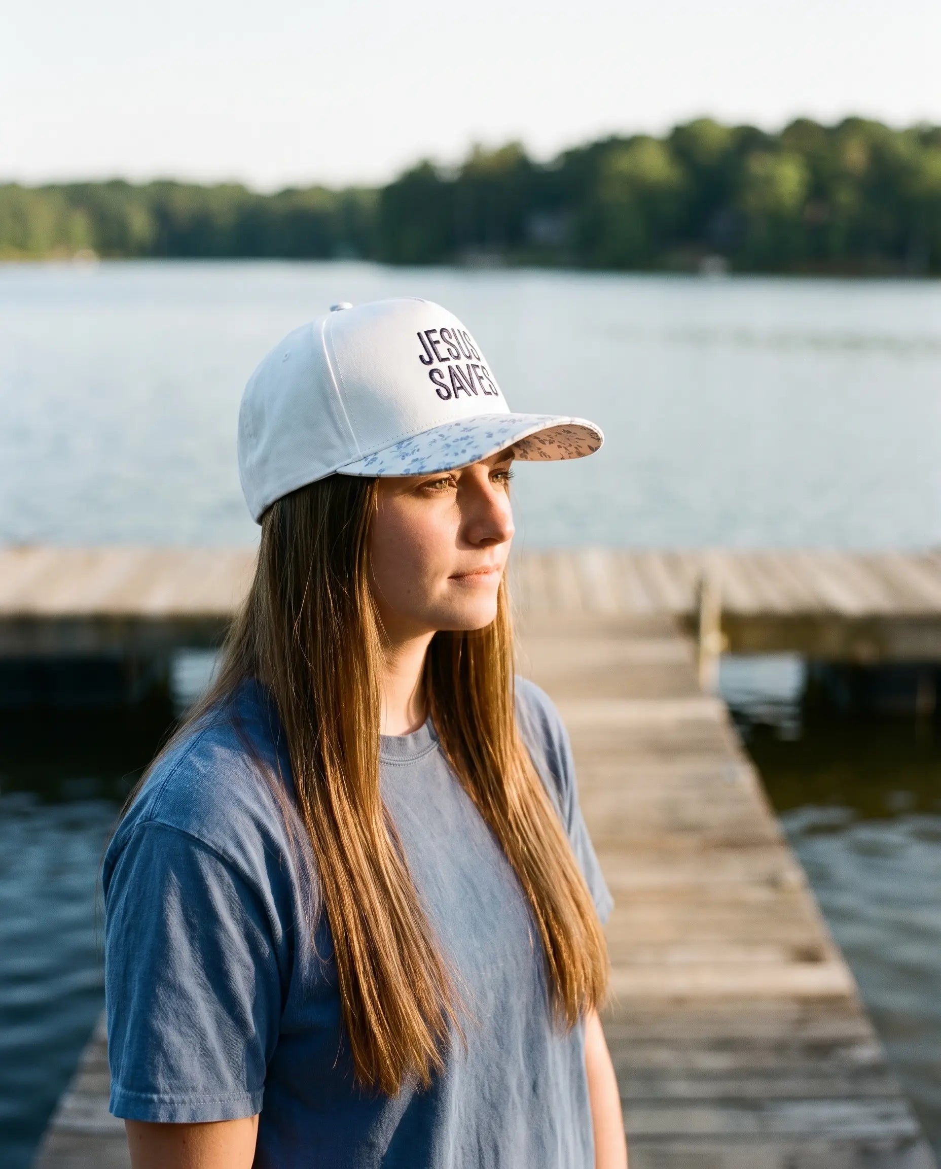 Model wearing the Jesus Saves Hat, Blue Floral